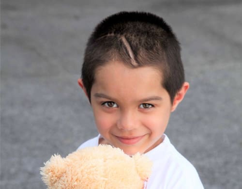 A kid with short trimmed hair