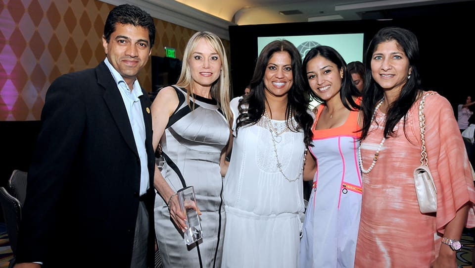 A group of five people in a photo op